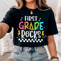 Rock your classroom in style with this Retro First Grade Rocks Teacher Shirt
